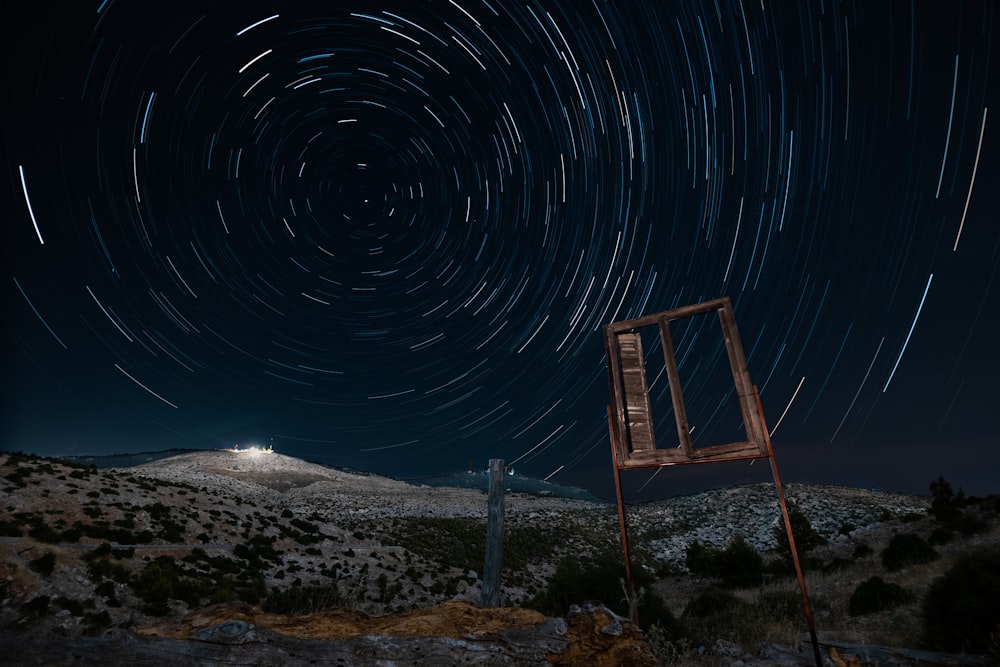 brown wooden ladder on brown sand during night time