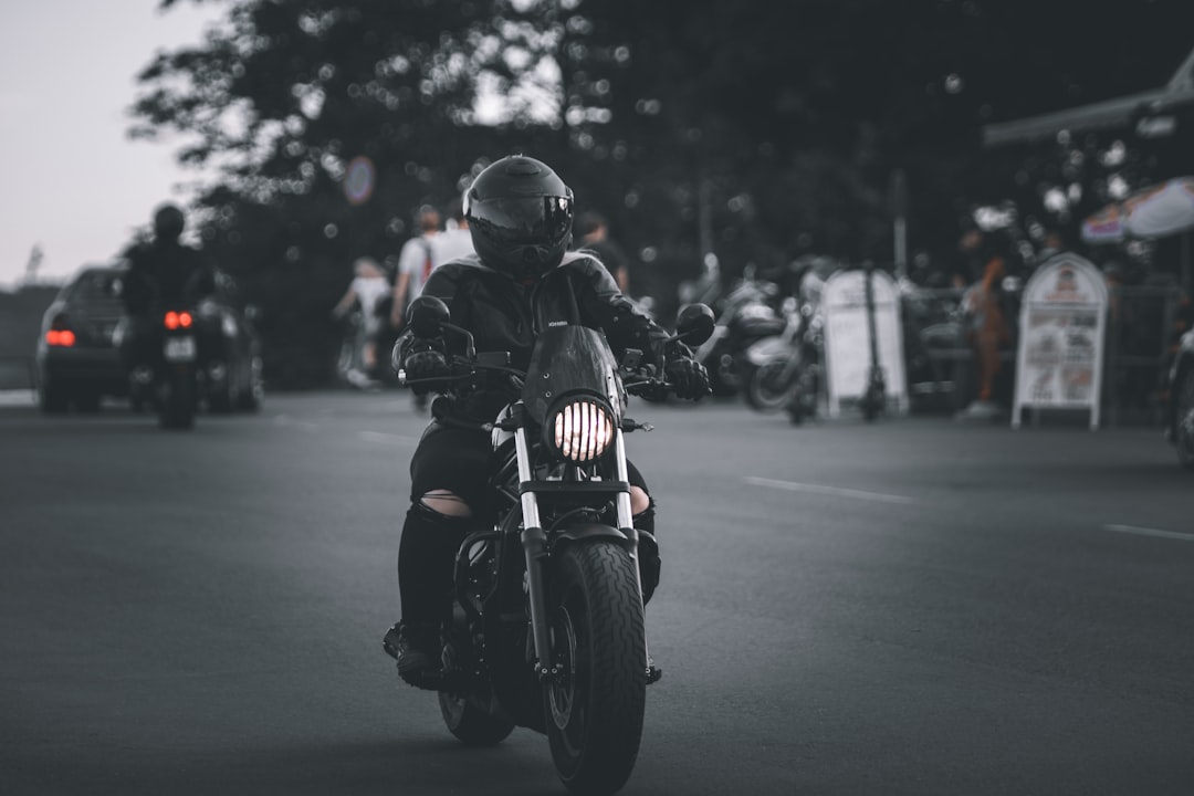 man in black motorcycle helmet riding motorcycle on road during daytime