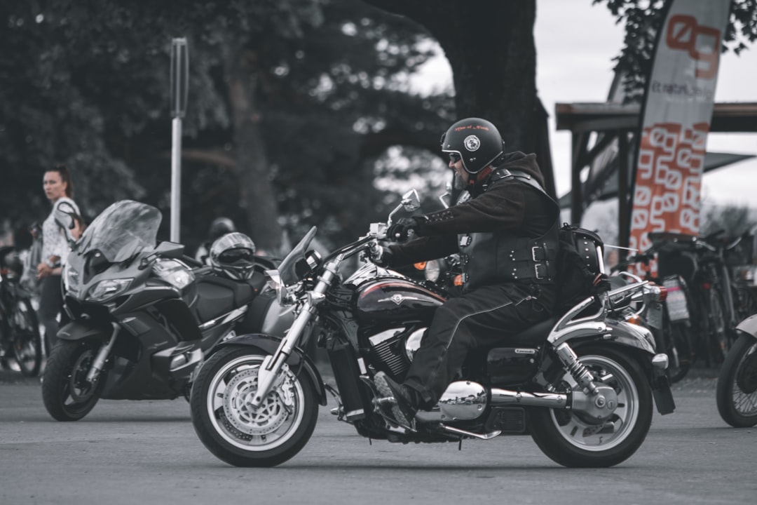 man in black helmet riding black motorcycle