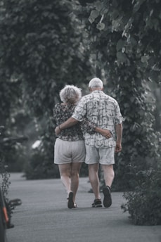 man and woman walking on the street during daytime