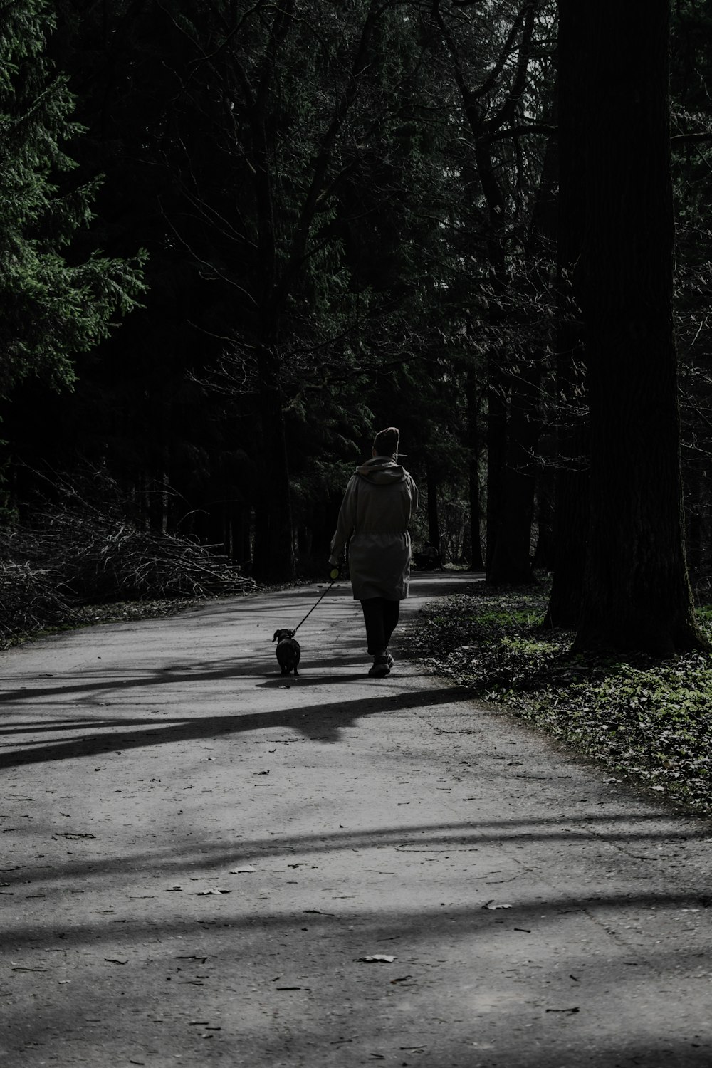 man in white jacket walking on road during daytime