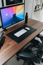 black flat screen computer monitor on brown wooden desk