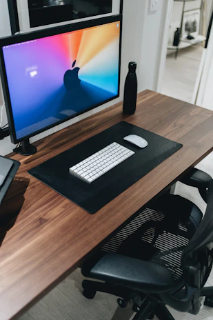 black flat screen computer monitor on brown wooden desk