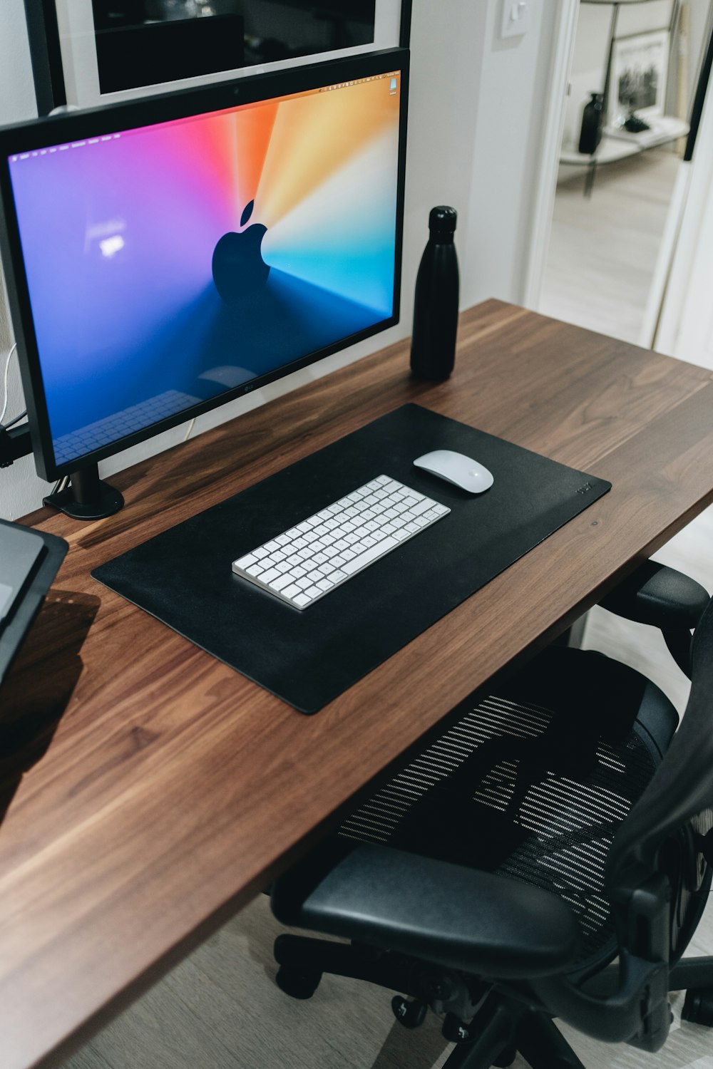 black flat screen computer monitor on brown wooden desk