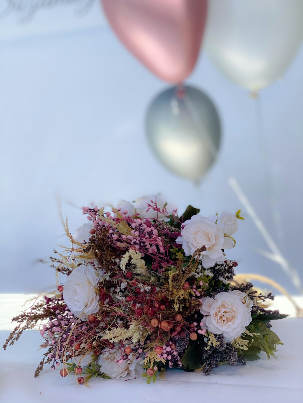 weiße und rosa Blumen mit Luftballons