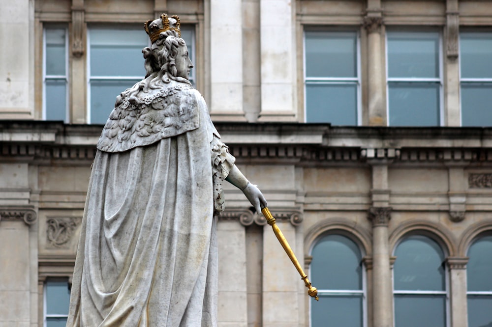 statue of man holding stick