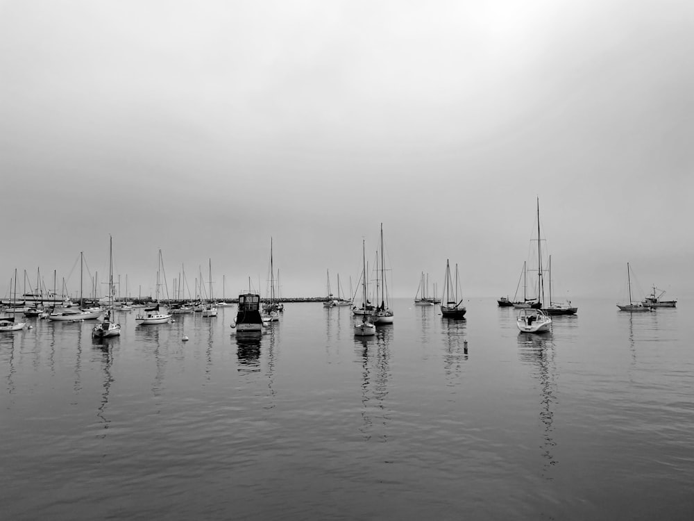 grayscale photo of boats on sea