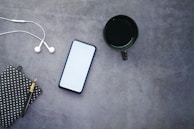 white iphone 5 c beside black round frame