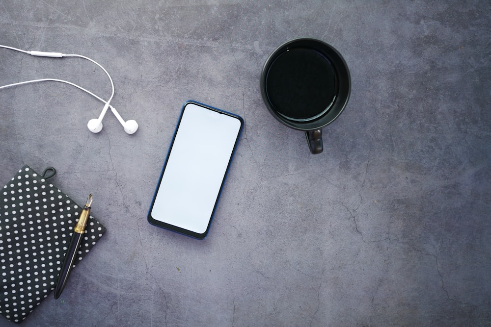 white iphone 5 c beside black round frame