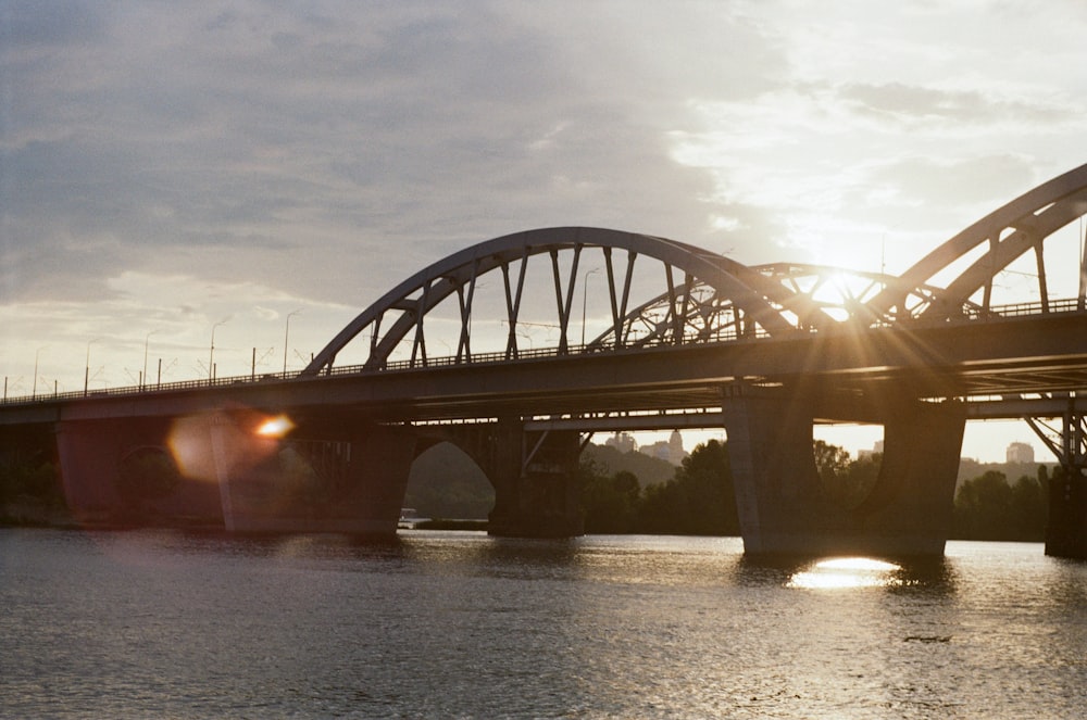 gray concrete bridge over body of water during daytime