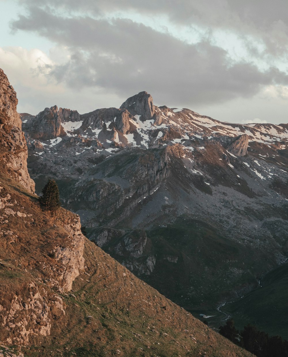 brown rocky mountain under white cloudy sky during daytime