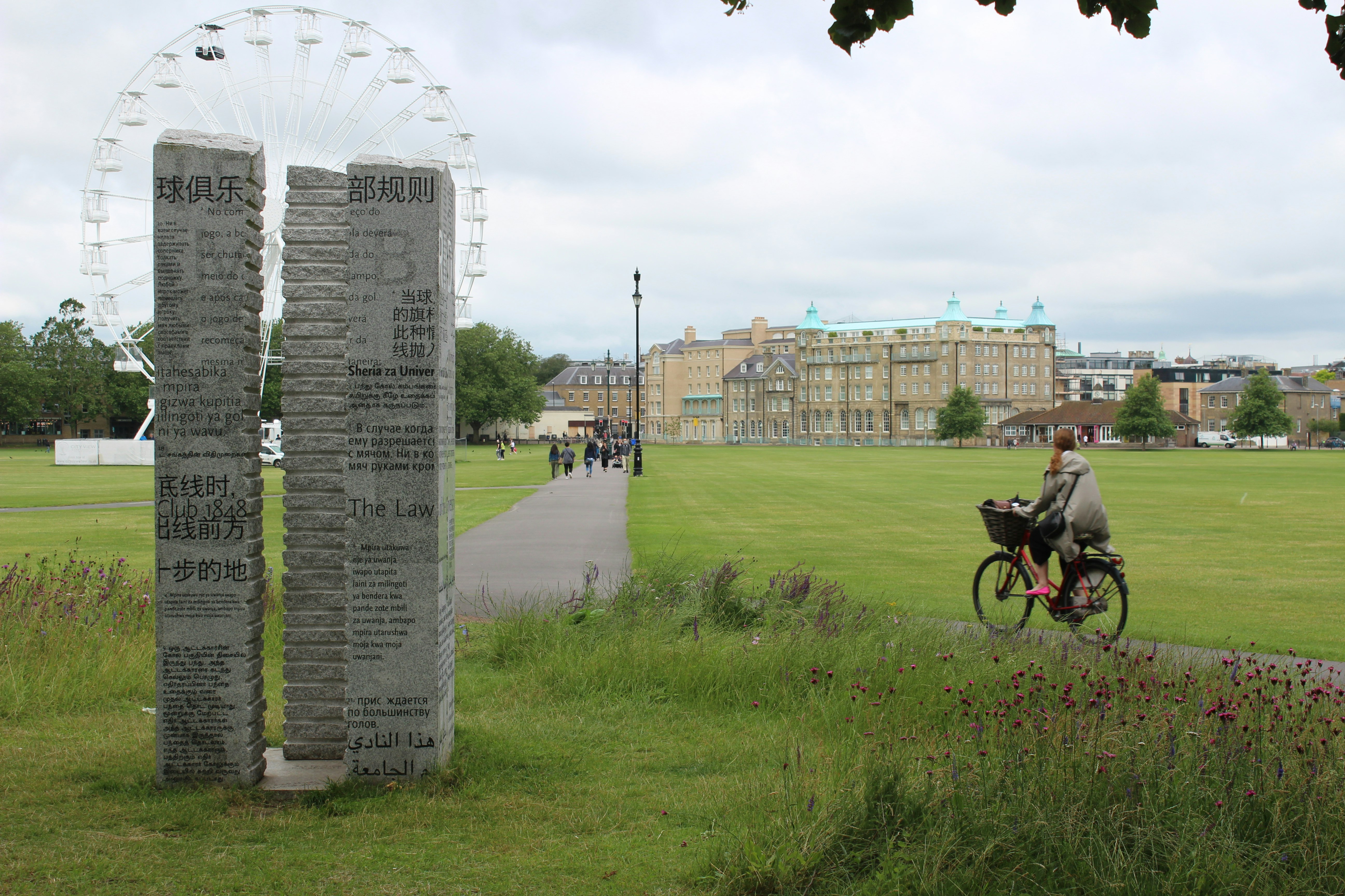 Stone marker commemorating the 1848 Cambridge Rules of football on Parker's Piece, Cambridge, UK.