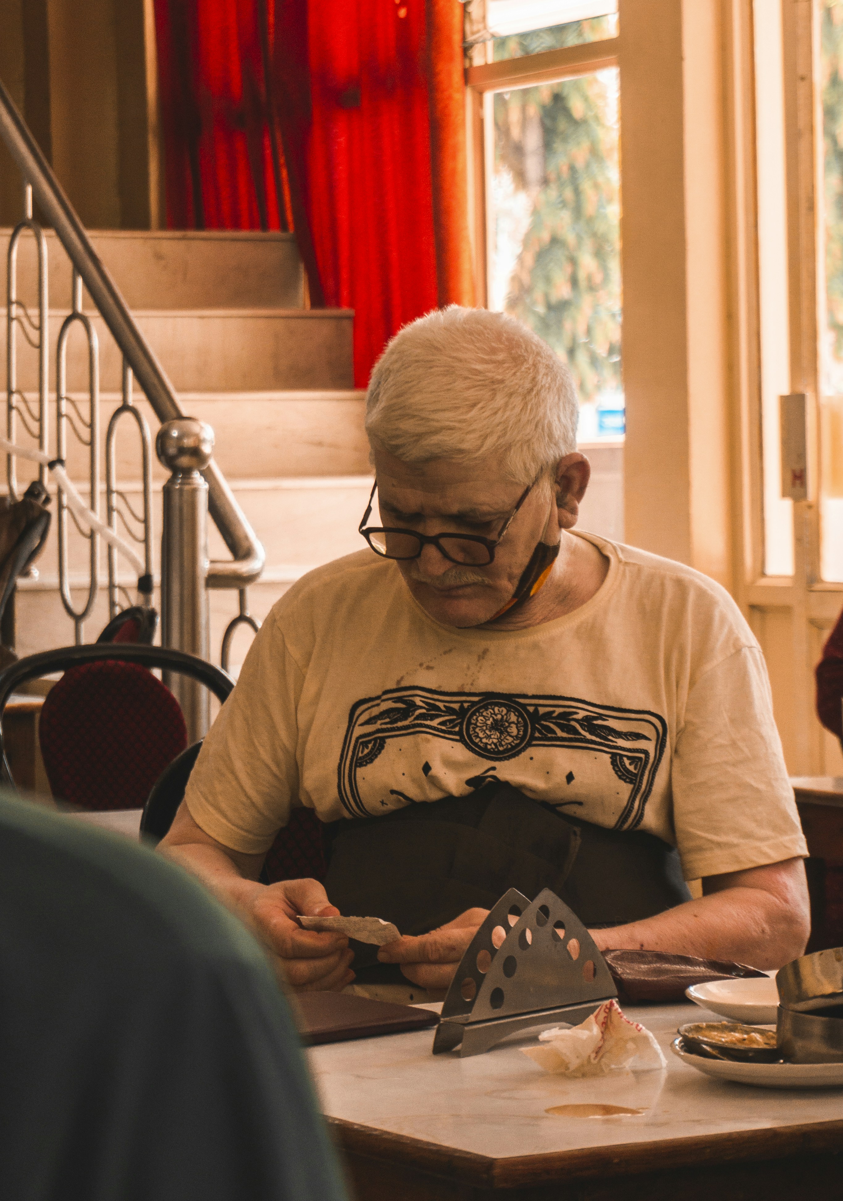 man in white crew neck t-shirt wearing black framed eyeglasses
