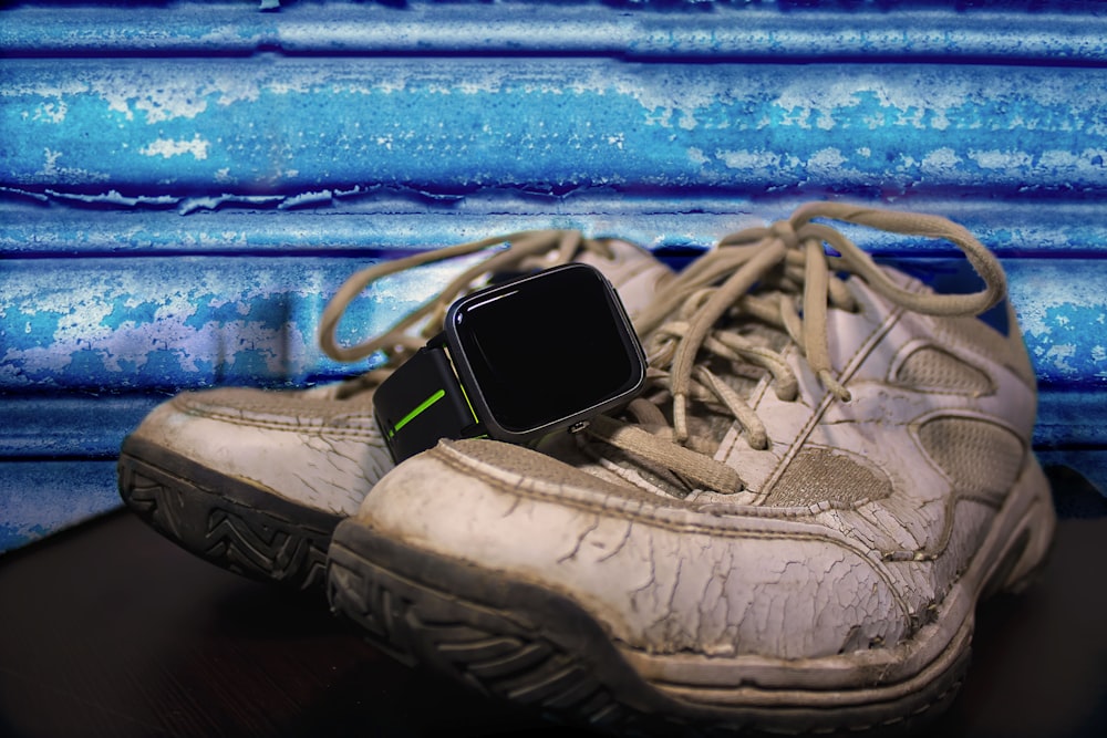 white and black samsung smartphone on blue textile