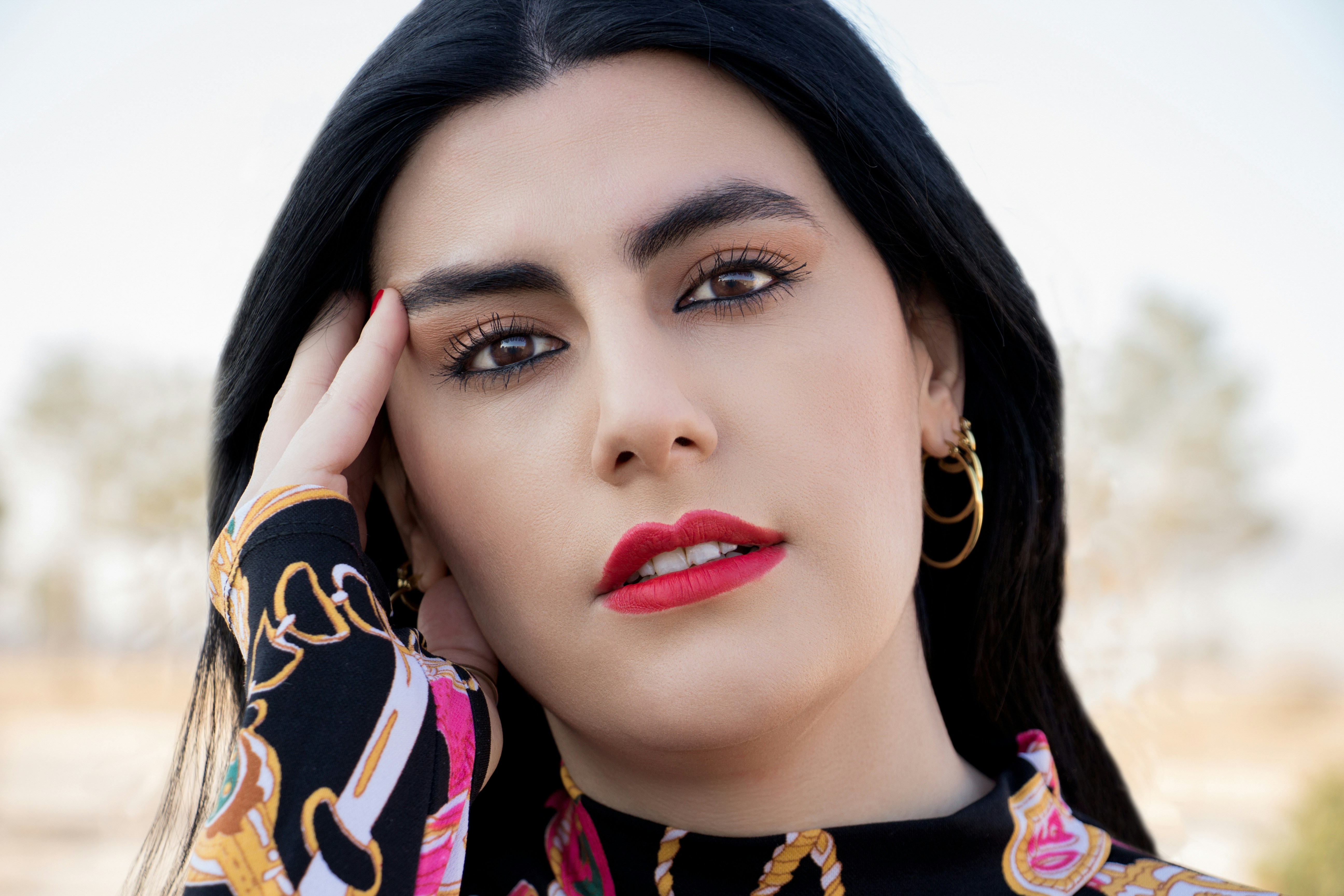 Mujer con camisa floral negra y amarilla