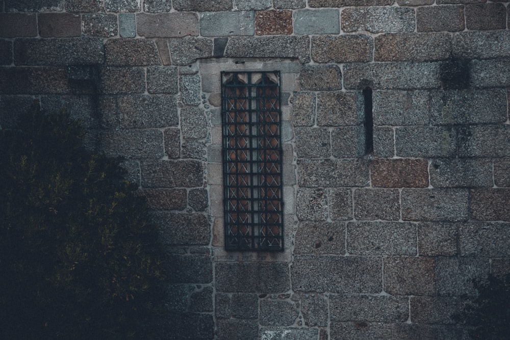 brown wooden window on brown brick wall