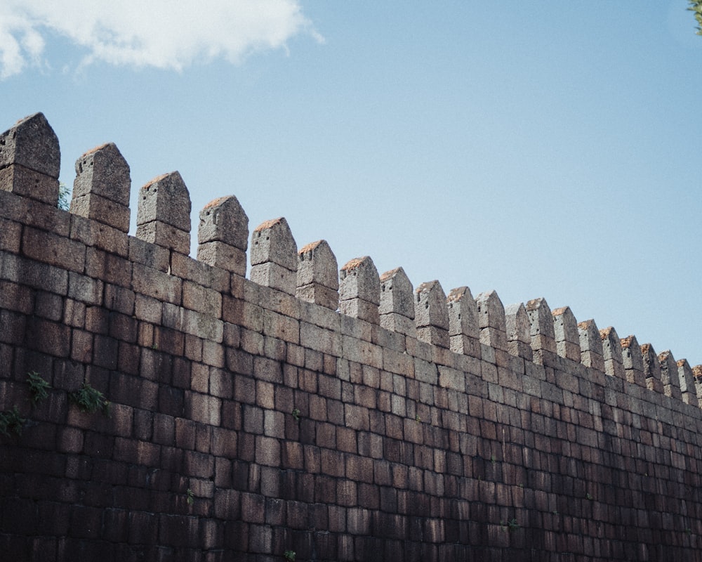 brown brick wall under blue sky during daytime