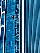 Technician inspecting and maintaining commercial building systems.