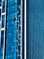 Image of a technician inspecting and maintaining a glass balcony.