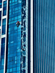 A professional inspecting a building facade with diagnostic tools.