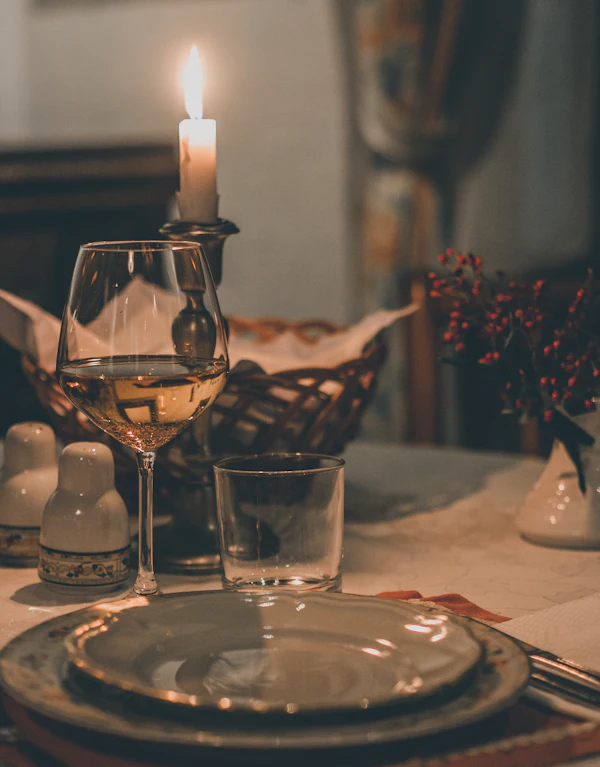 A wine glass by candlelight