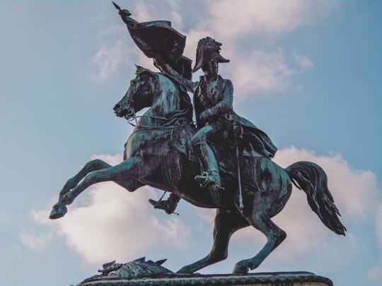 man riding horse statue under white clouds during daytime in Heldenplatz Austria