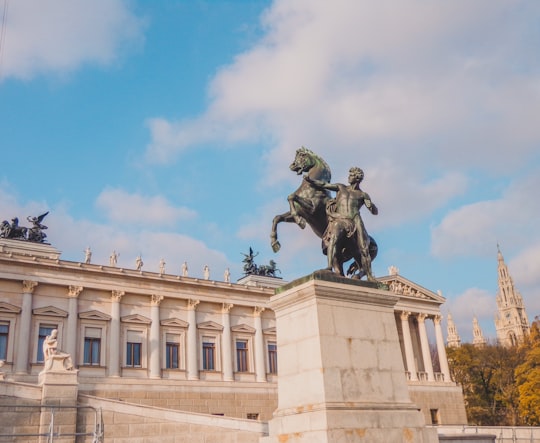 man riding horse statue under blue sky during daytime in Volksgarten Austria