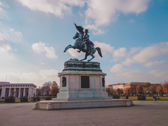 man riding horse statue under cloudy sky during daytime in Heldenplatz Austria