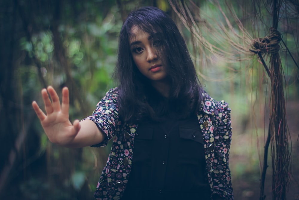 woman in black vest and white and black floral long sleeve shirt