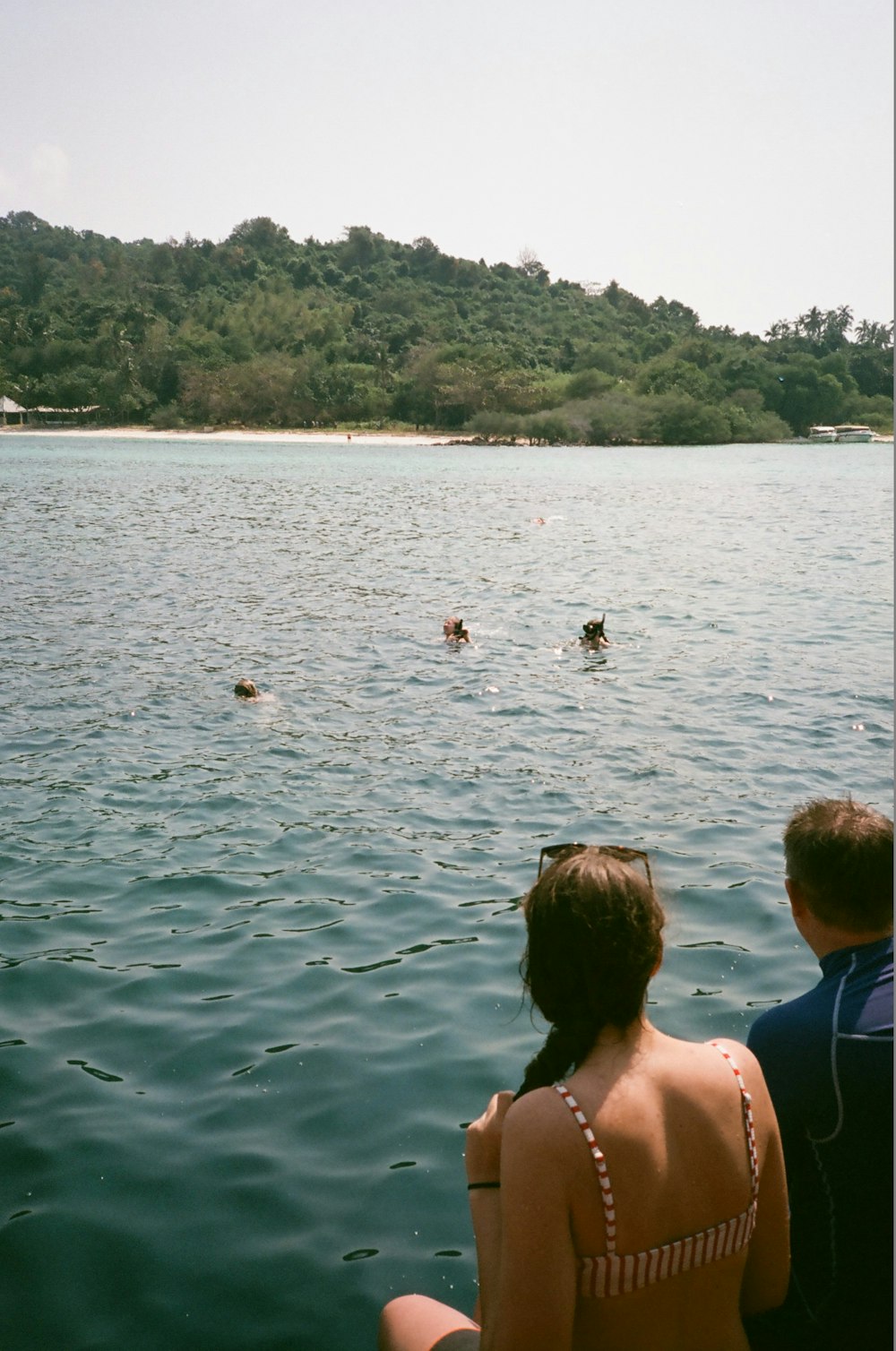 people swimming on lake during daytime