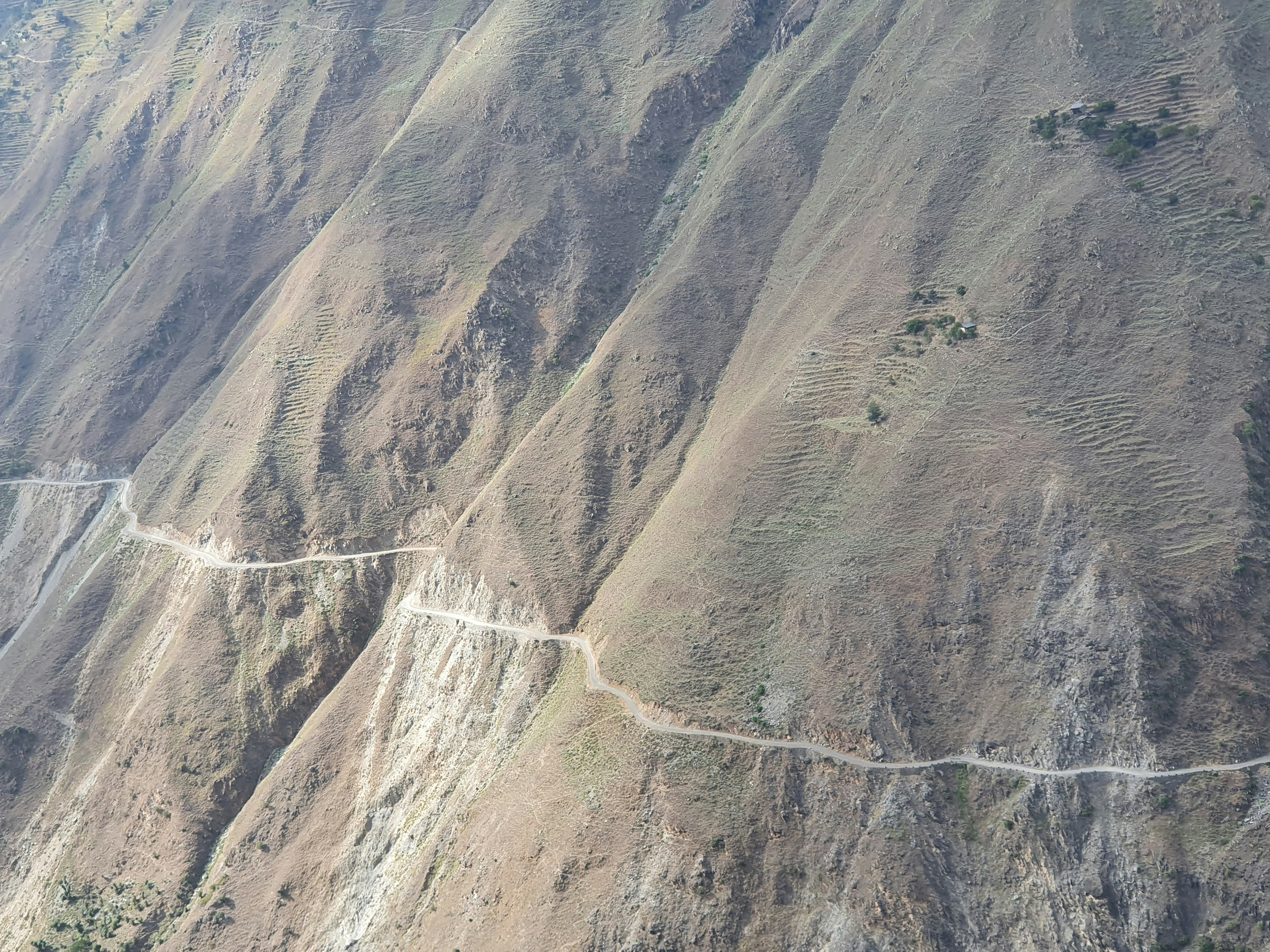 aerial view of green and brown mountains during daytime