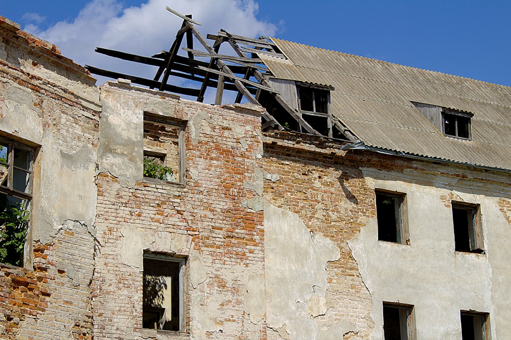 brown brick building with black metal roof