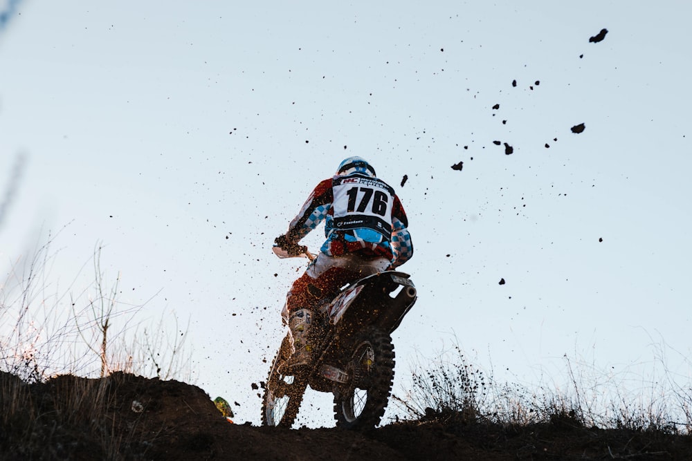 man in blue and red helmet riding motocross dirt bike