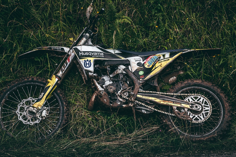 yellow and black motocross dirt bike on green grass field