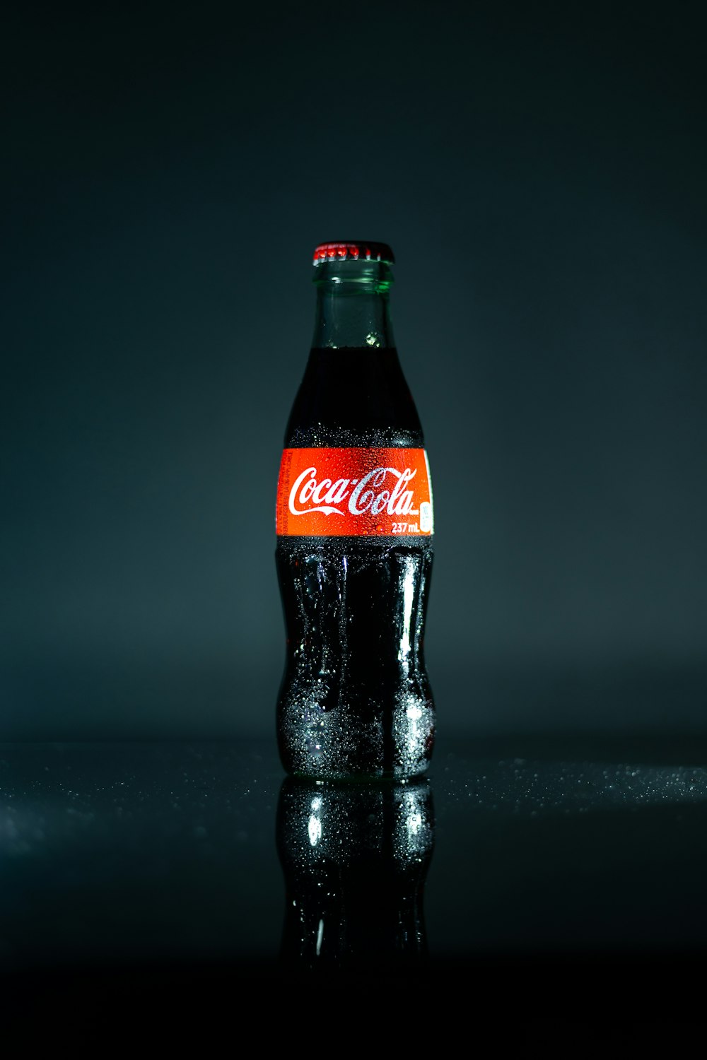 coca cola bottle on black table