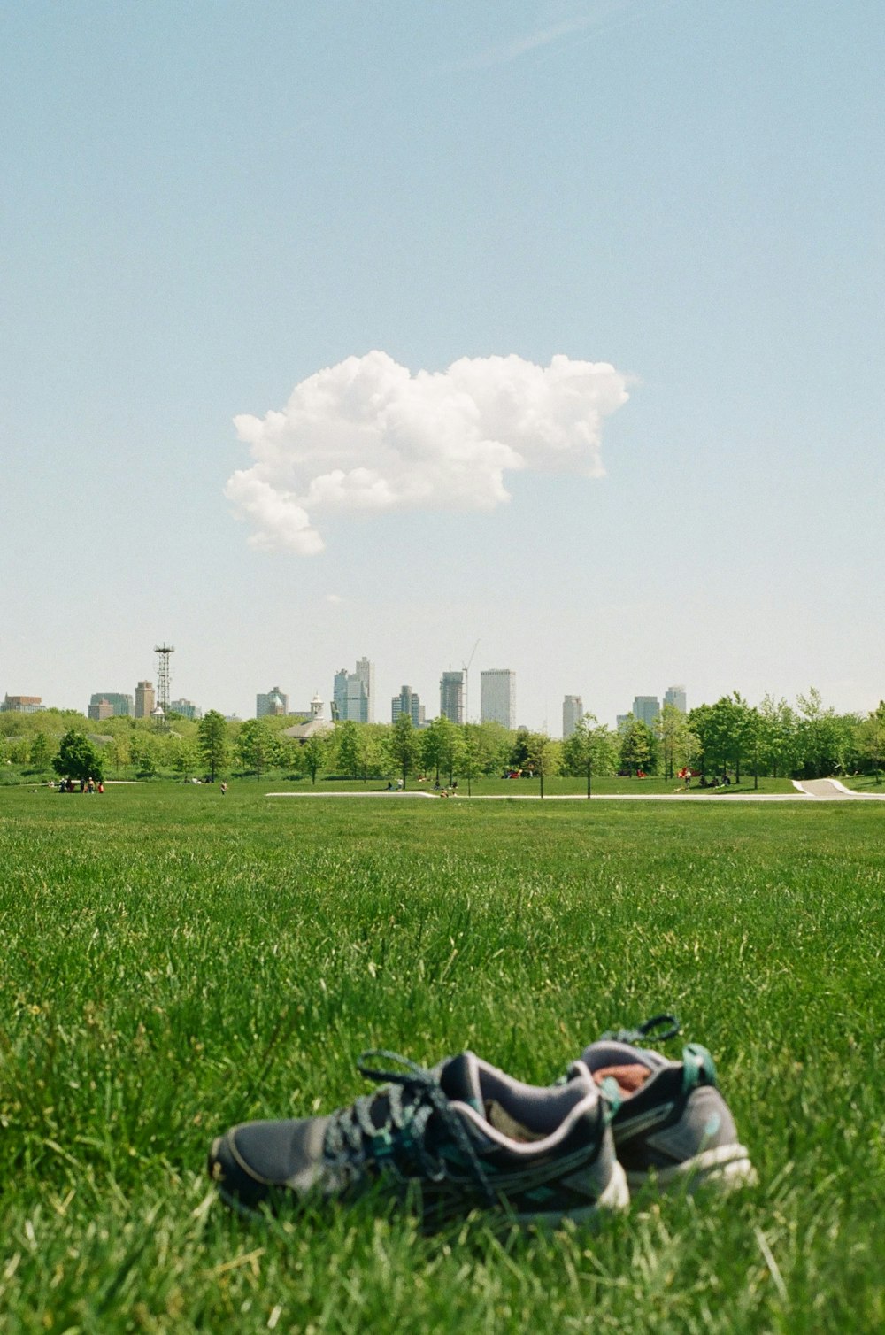 person lying on green grass field during daytime