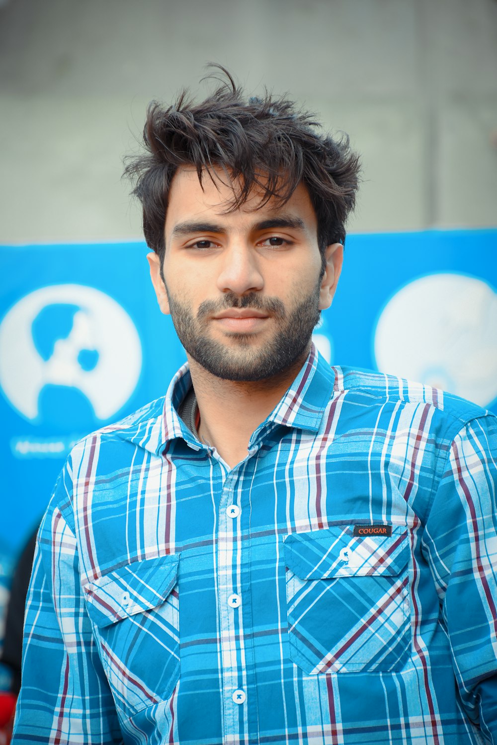 man in blue red and white plaid button up shirt