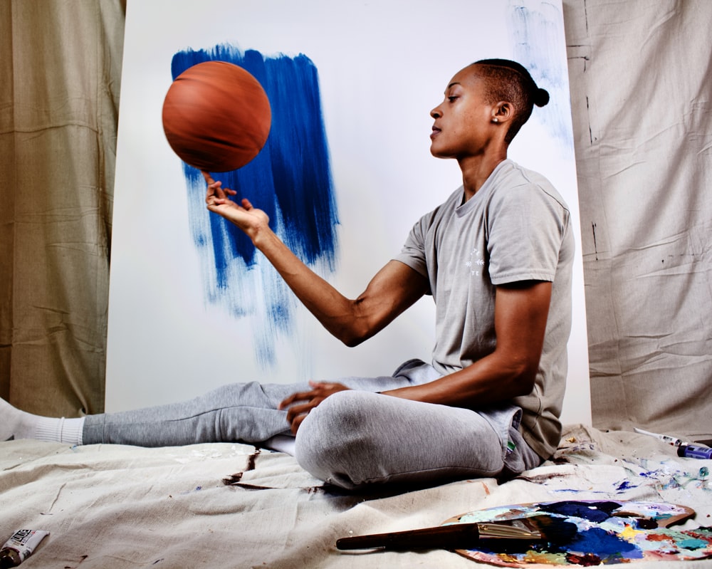 boy in gray crew neck t-shirt and gray pants sitting on white bed