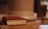 Close-up of a book cover titled 'Breaking Silence' resting on a wooden table.