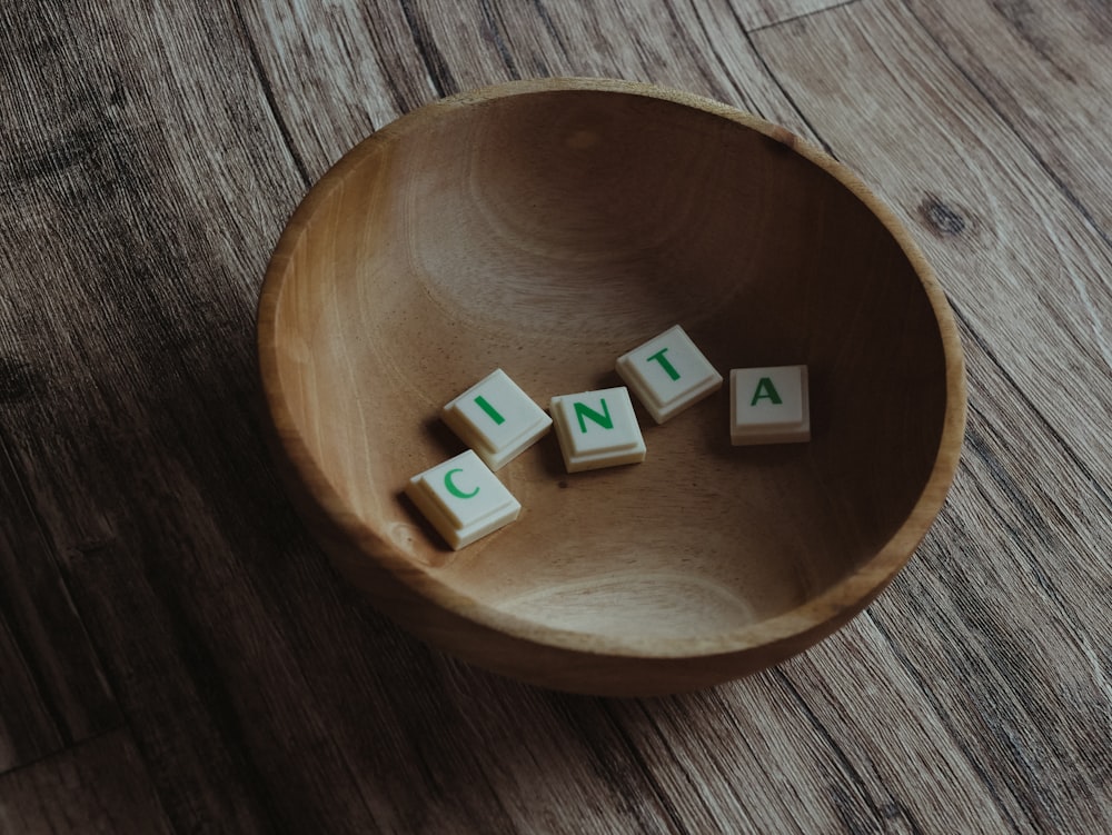 white and green lego blocks on brown wooden round plate