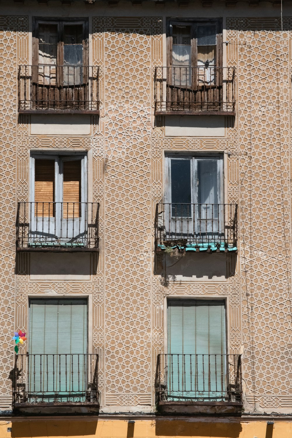 brown concrete building with blue window