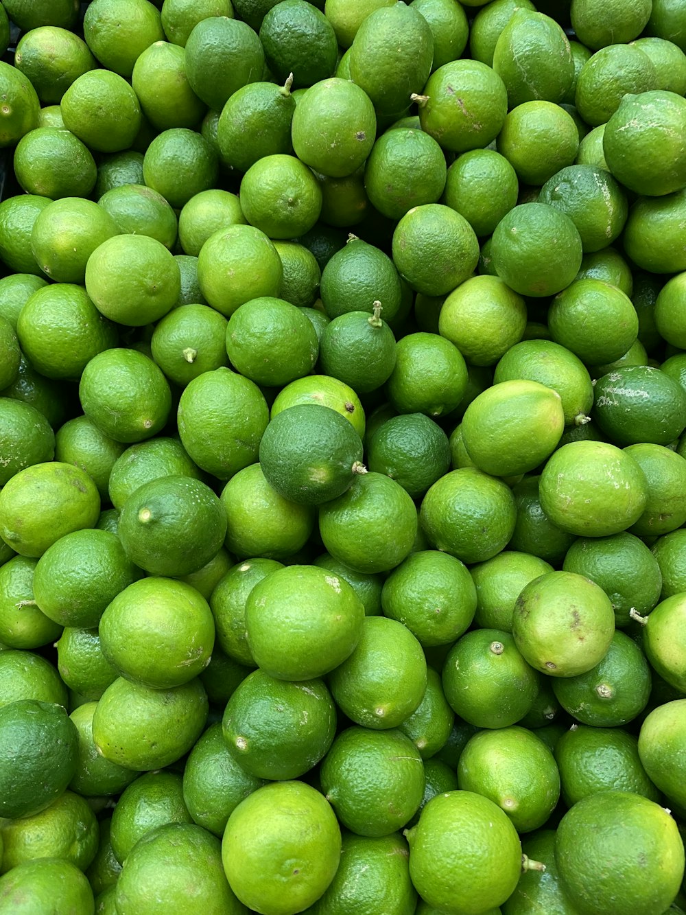 green lime fruit in close up photography