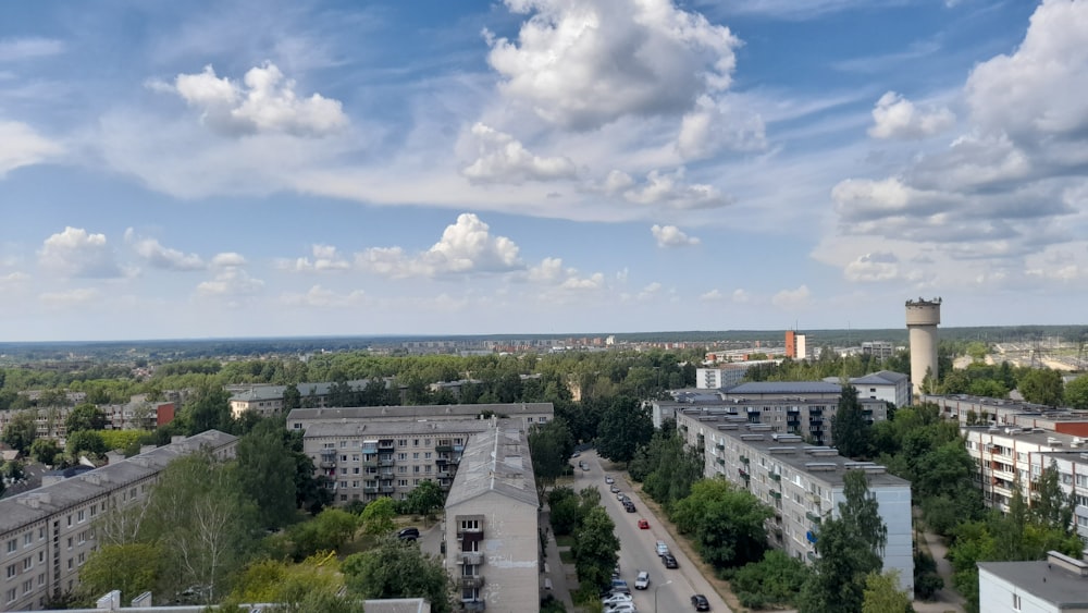 cars on road near city buildings during daytime