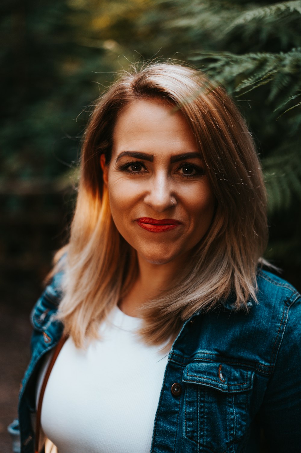 woman in blue denim jacket smiling