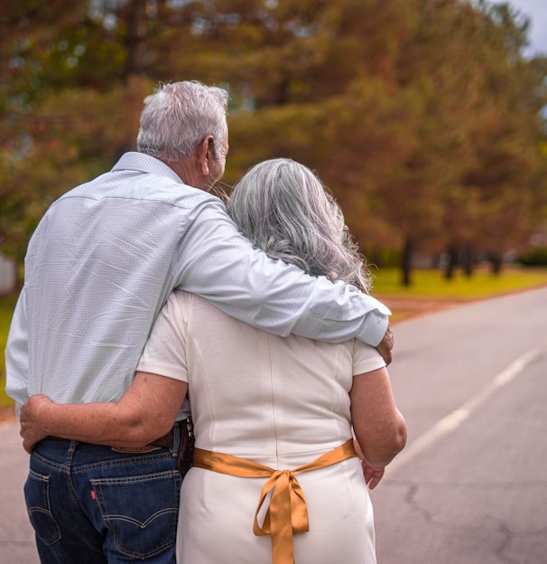 couple kissing on the road during daytime