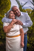 man in white dress shirt hugging woman in white dress
