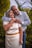 man in white dress shirt hugging woman in white dress