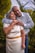 man in white dress shirt hugging woman in white dress