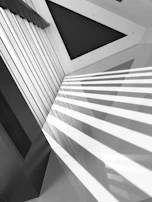 Architectural shot of a minimalist interior agencement highlighting sharp edges and balanced proportions.