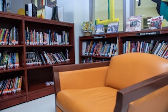 A group of diverse readers discussing books in a cozy library corner.